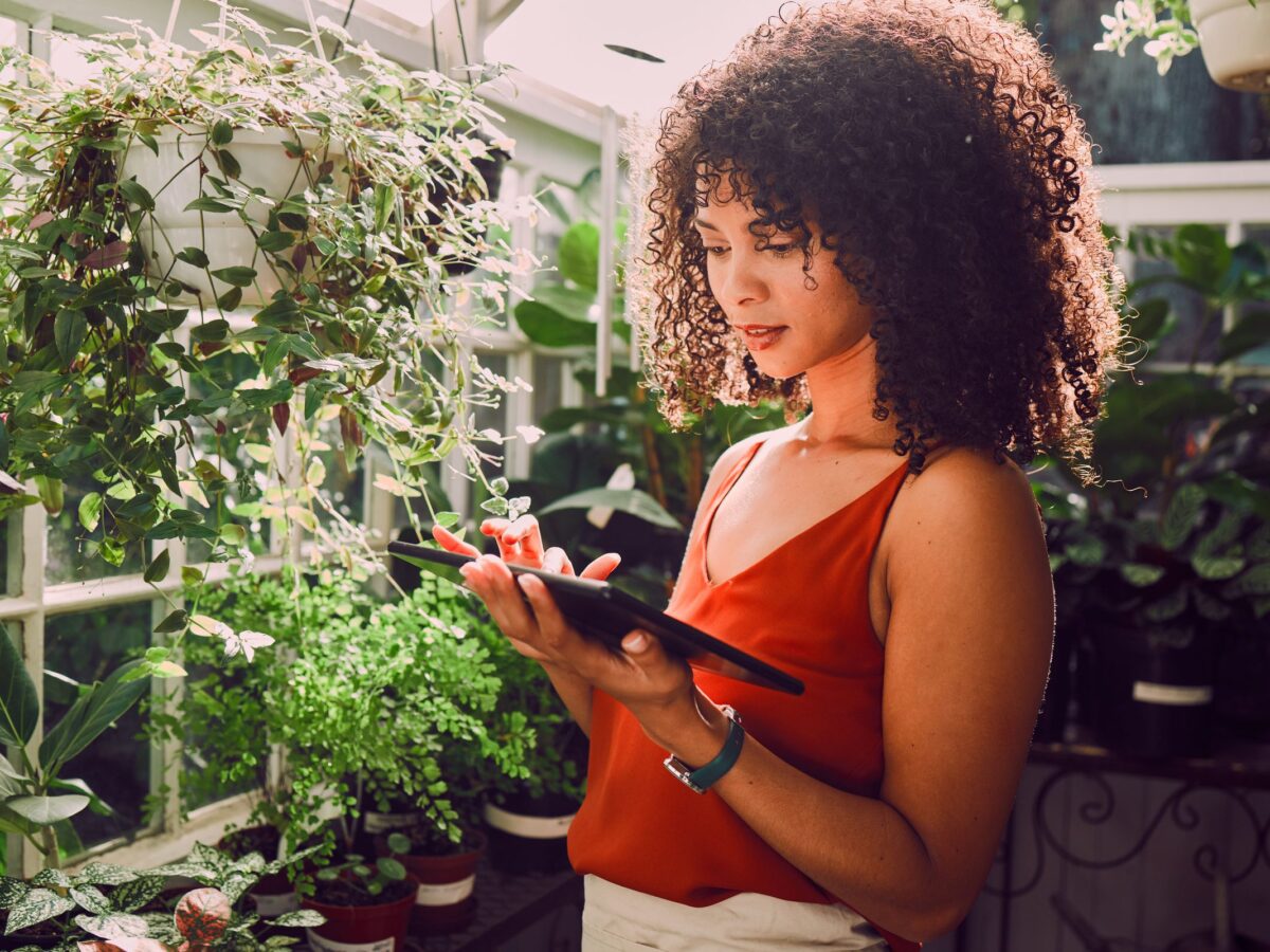 Plant shop owner reviewing her Amazon account performance on a tablet